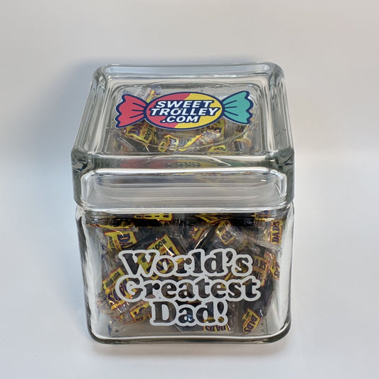 Clear glass jar filled with candy and 'World's Greatest Dad!' text, branded with Sweet Trolley.com on a white background.