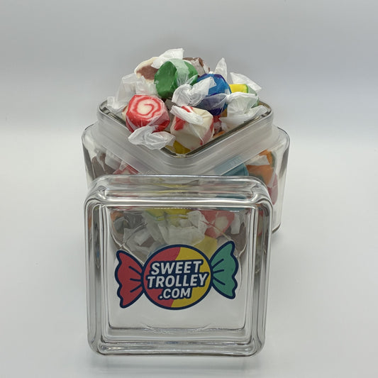 Clear glass jar filled with colorful salt water taffy and a 'Sweet Trolley' logo on a white background